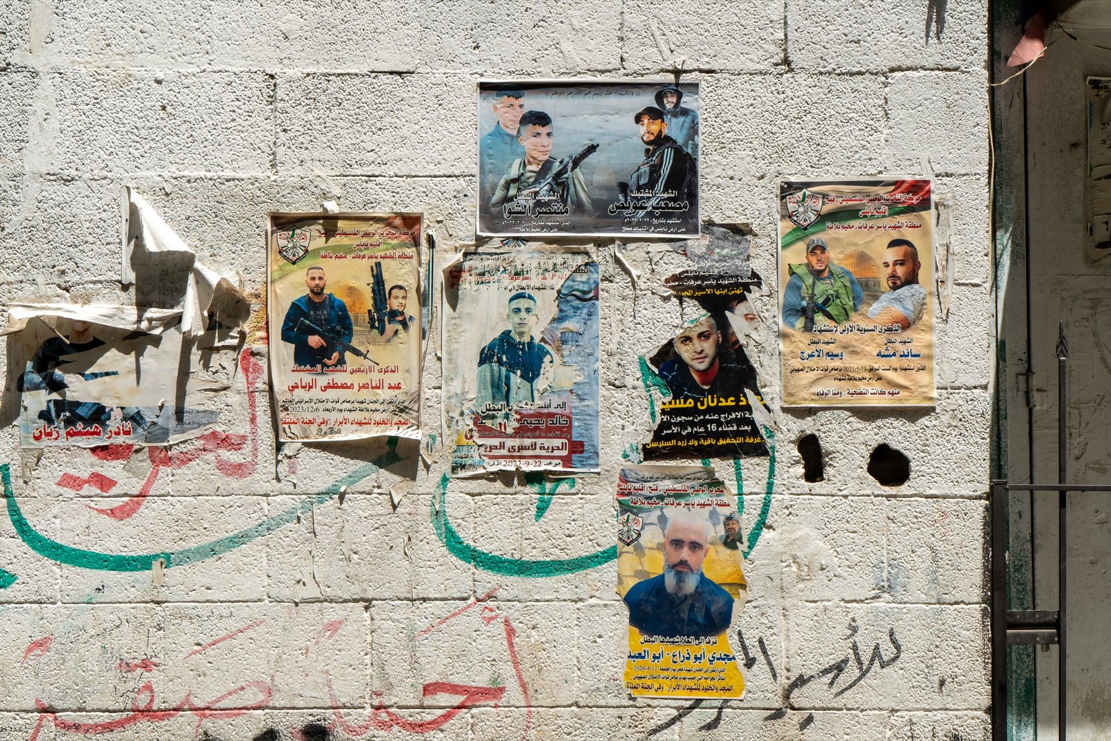Political posters layered on a wall