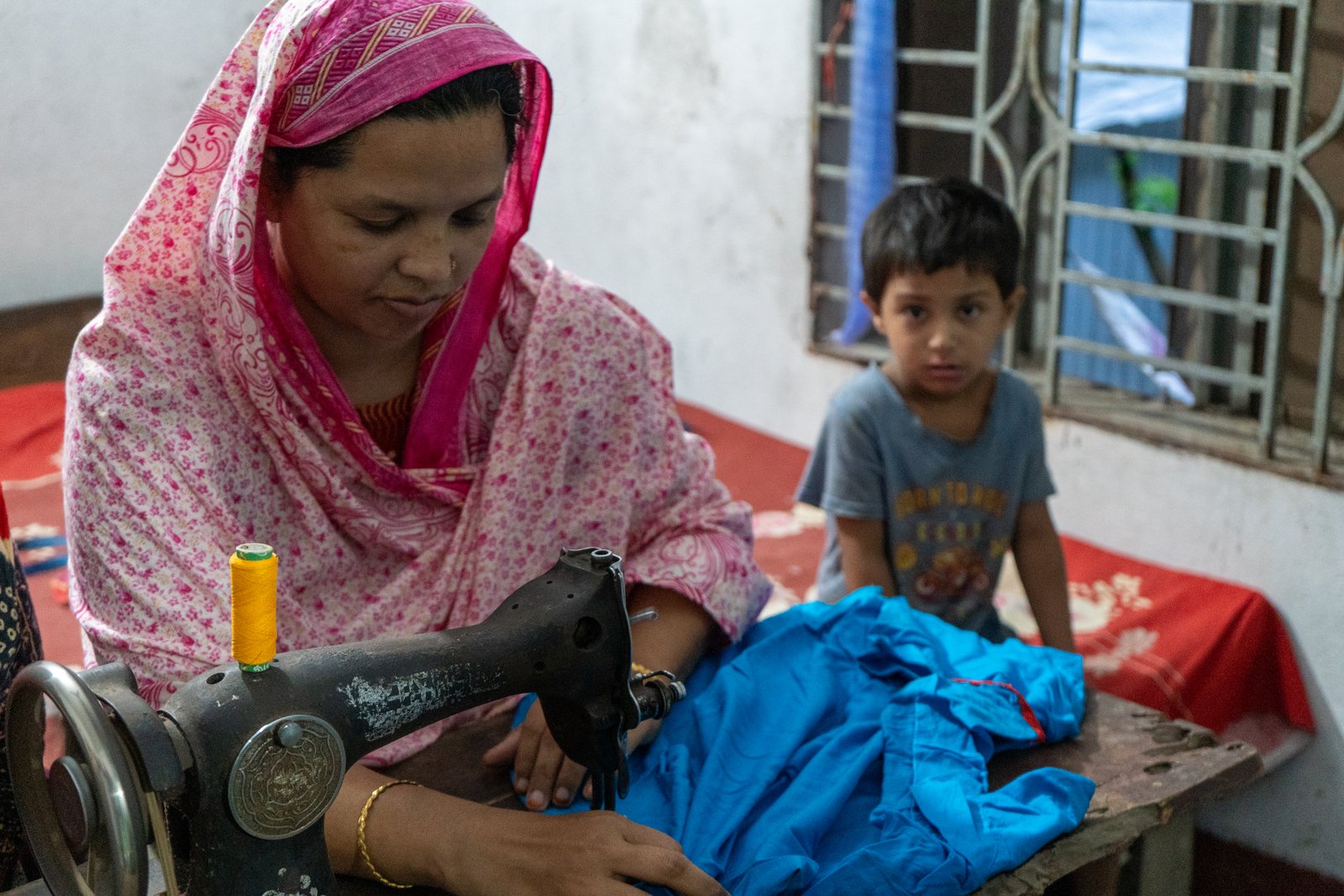 Woman showing fabric and sewing materials at her home business