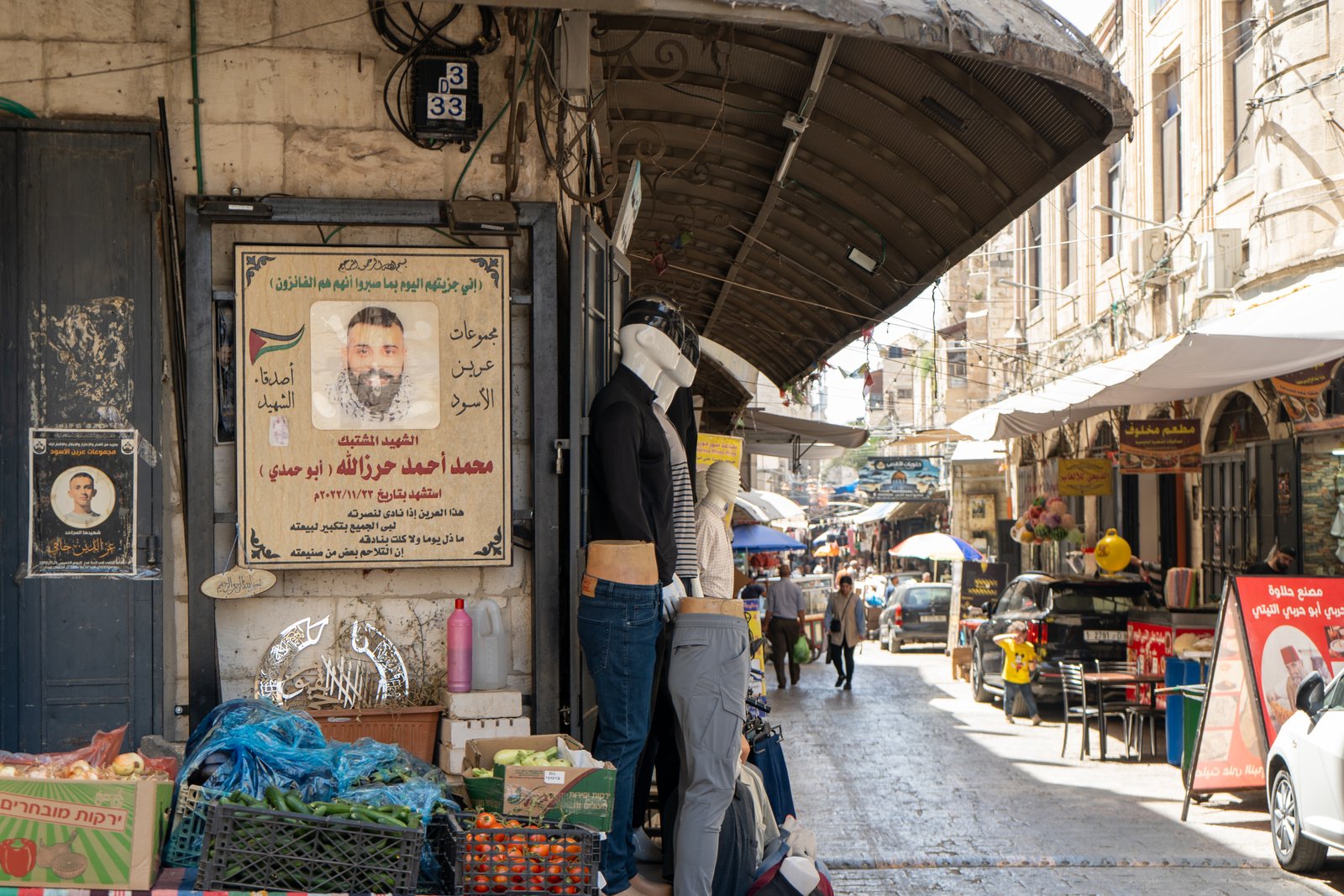 Memorial poster displayed beside the main shopping street in Nablus