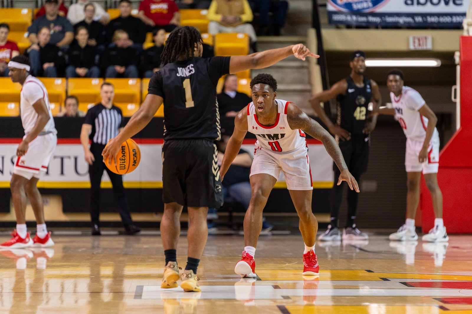 Basketball players positioned across the court