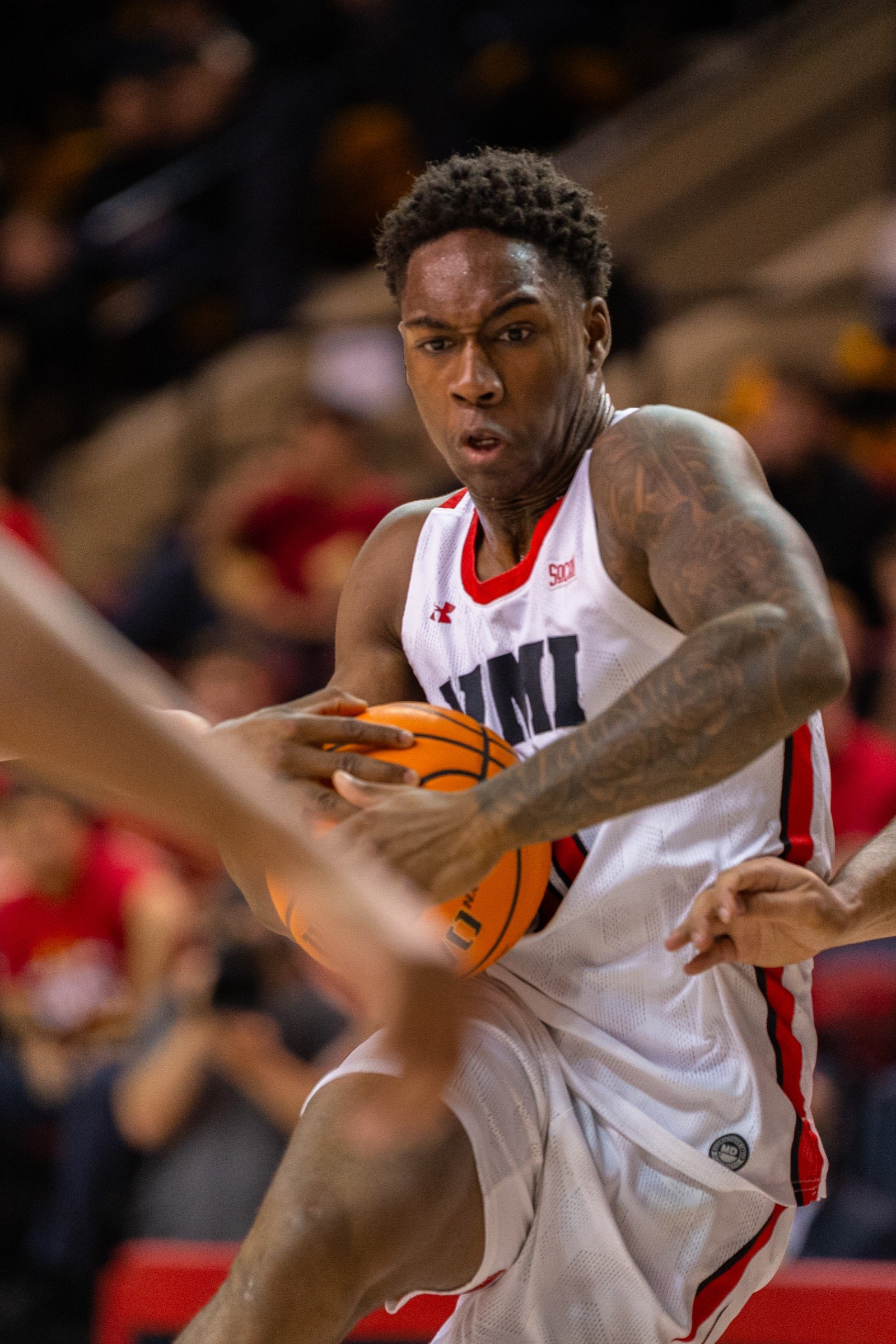 Basketball player fighting through traffic with the ball